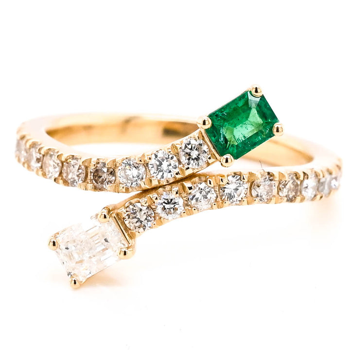 14KT Yellow Gold 0.21CT Emerald & Diamond Crossover Ring.

Diamonds: